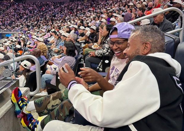 Valkyries fans Tonishia Short and Charles Bennett share a laugh in between timeouts. (Courtesy of ValQueeries)