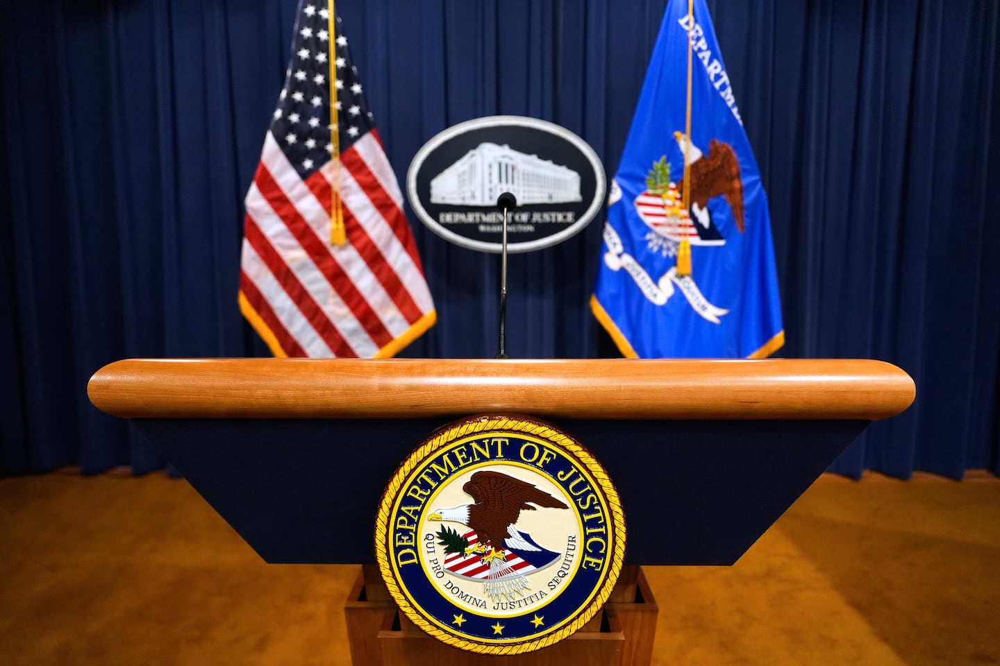 The US Department of Justice logo on a podium before a press conference at the Justice Department.