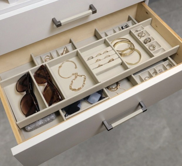 Accessory and jewelry trays like these from California Closets protect and organize smaller items inside a drawer. Simply slide the top tray to one side to reach items below. (California Closets)