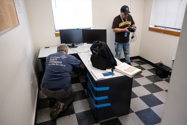 San Diego, CA - Paul Sheck, program manager for the day center, and Paul DeLessio, director of coordinating services, pack up an office on Wednesday, Sept. 30, 2026, at the Neil Good Day Center in San Diego, CA. (Luke Johnson / The San Diego Union-Tribune)