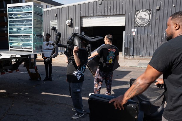 San Diego, CA - Volunteers from the Navy move furniture into a moving truck on Wednesday, Sept. 30, 2026, at the Neil Good Day Center in San Diego, CA. (Luke Johnson / The San Diego Union-Tribune)