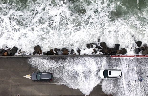 Oceanside, CA - October 11: Waves break along The Strand during a high tide as the remnants of Tropical Storm Rachel moved through the region on October 11, 2026 in Oceanside, CA. (K.C. Alfred / The San Diego Union-Tribune)
