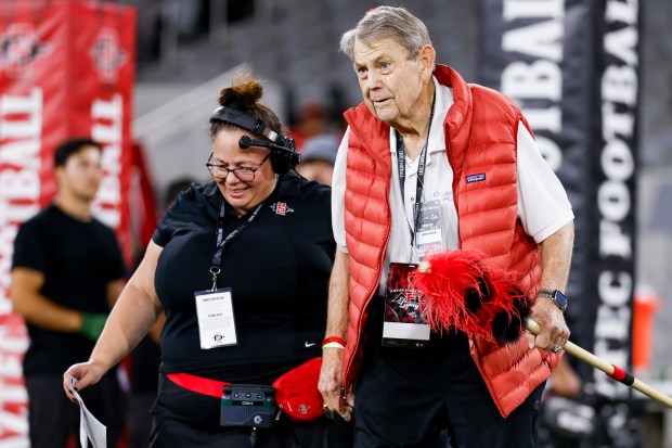 Former San Diego State quarterback Don Horn is escorted onto the field before the Aztecs' game against Fresno State at Snapdragon Stadium on Saturday, Oct. 17, 2026 in San Diego, California. (Meg McLaughlin / The San Diego Union-Tribune)