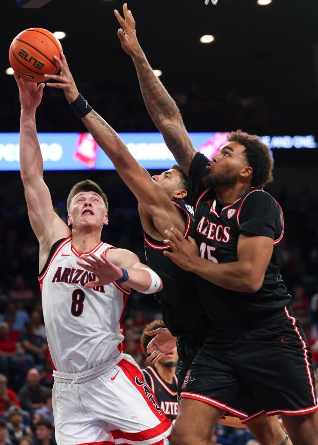 San Diego State forward Tae Simmons (8) blocks Arizona forward Ivan Kharchenkov's layup attempt during the first half of Friday's exhibition gmae in Tucson, Ariz. (Grace Trejo, Arizona Daily Star)