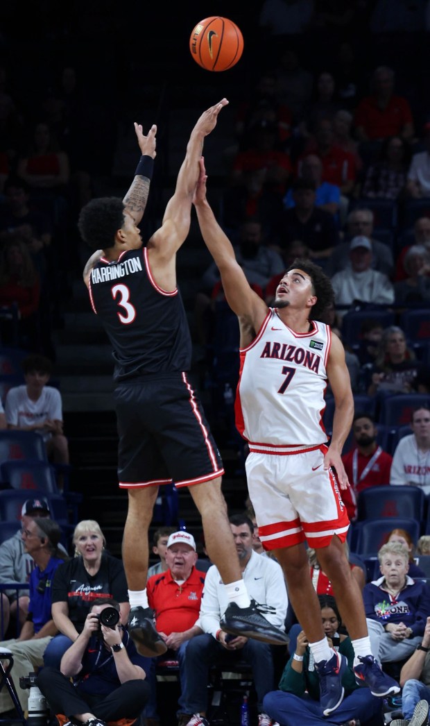 San Diego State guard Elzie Harrington (3) shoots over Arizona guard Derek Dixon (7) during the first half of Friday's exhibition game in Tucson, Ariz. (Grace Trejo, Arizona Daily Star)