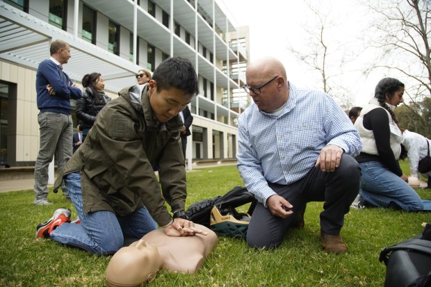 Revive & Survive San Diego kick-off press conference. Denis Chang practices CPR on a mannequin with Patrick Patrick O'Neill a volunteer at UC San Diego in La Jolla on Monday, Feb. 26, 2024 in San Diego, California. (Alejandro Tamayo / The San Diego Union-Tribune)