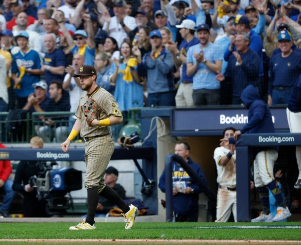 Jake Cronenworth walks back after an error in the seventh inning of Sunday's National League Division Series loss to the Brewers. (K.C. Alfred / The San Diego Union-Tribune)
