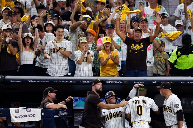 Fans celebrate after Samad Taylor of the San Diego Padres scored a run against the Milwaukee Brewers during the third inning in Game 3 of the National League Division Series at Petco Park on Tuesday, Oct. 6, 2026 in San Diego, California. (Meg McLaughlin / The San Diego Union-Tribune)