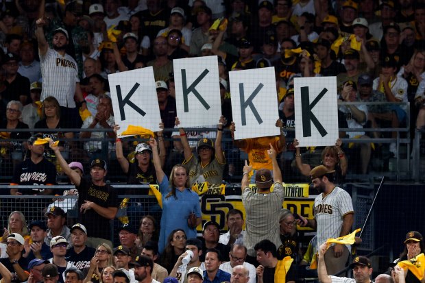 San Diego Padres fans hold up signs as Joe Musgrove pitches against the Milwaukee Brewers during the eighth inning in game four of the National League Division Series at Petco Park on Wednesday, Oct. 7, 2026 in San Diego, California. (Meg McLaughlin / The San Diego Union-Tribune)
