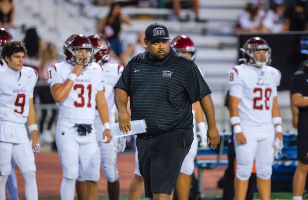 Mision Hills coach Thomas Altieri looks across the field as his team warms up for last week's game vs. La Costa Canyon. (Charlie Neuman / For The San Diego Union-Tribune)