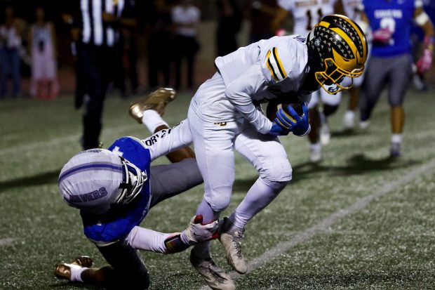 San Diego's Kye Cooper tackles Mission Bay's Jayden Marcelino during their game at Balboa Stadium on Friday, Oct. 9, 2026 in San Diego, California. (Meg McLaughlin / The San Diego Union-Tribune)