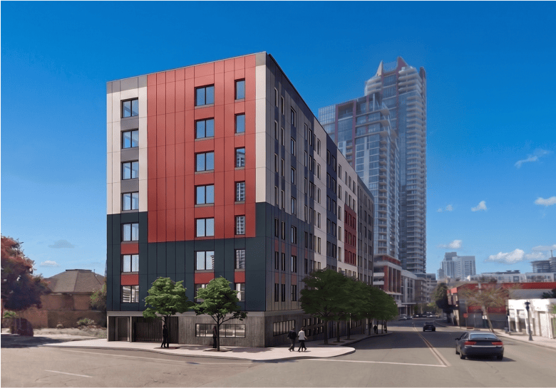 a boxy building with randomly colored red, gray and tan rectangles on the exterior.