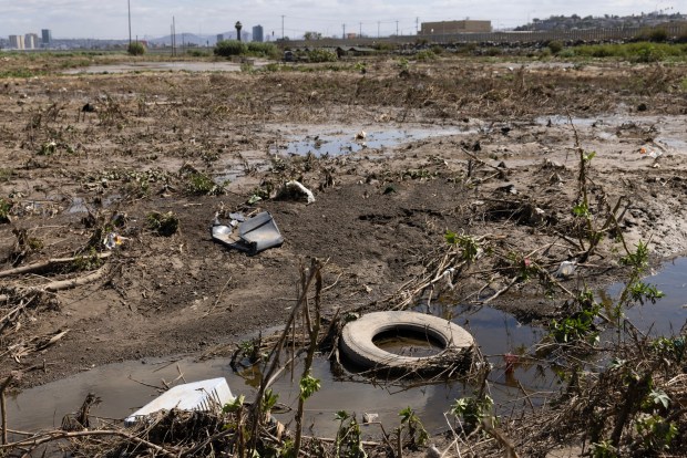 Imperial Beach, CA - Trash clumps along the bank of the Tijuana River in the Tijuana River Valley on Tuesday, Oct. 13, 2026, in Imperial Beach, CA. (Luke Johnson / The San Diego Union-Tribune)
