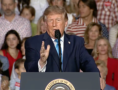 President Donald Trump speaks at a rally in front of a crowd