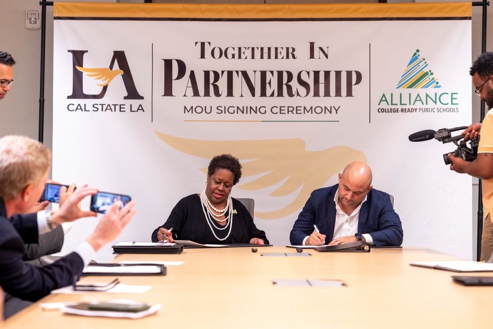 Cal State LA and Alliance College-Ready Public Schools representatives sign a memorandum of understanding during a partnership ceremony.
