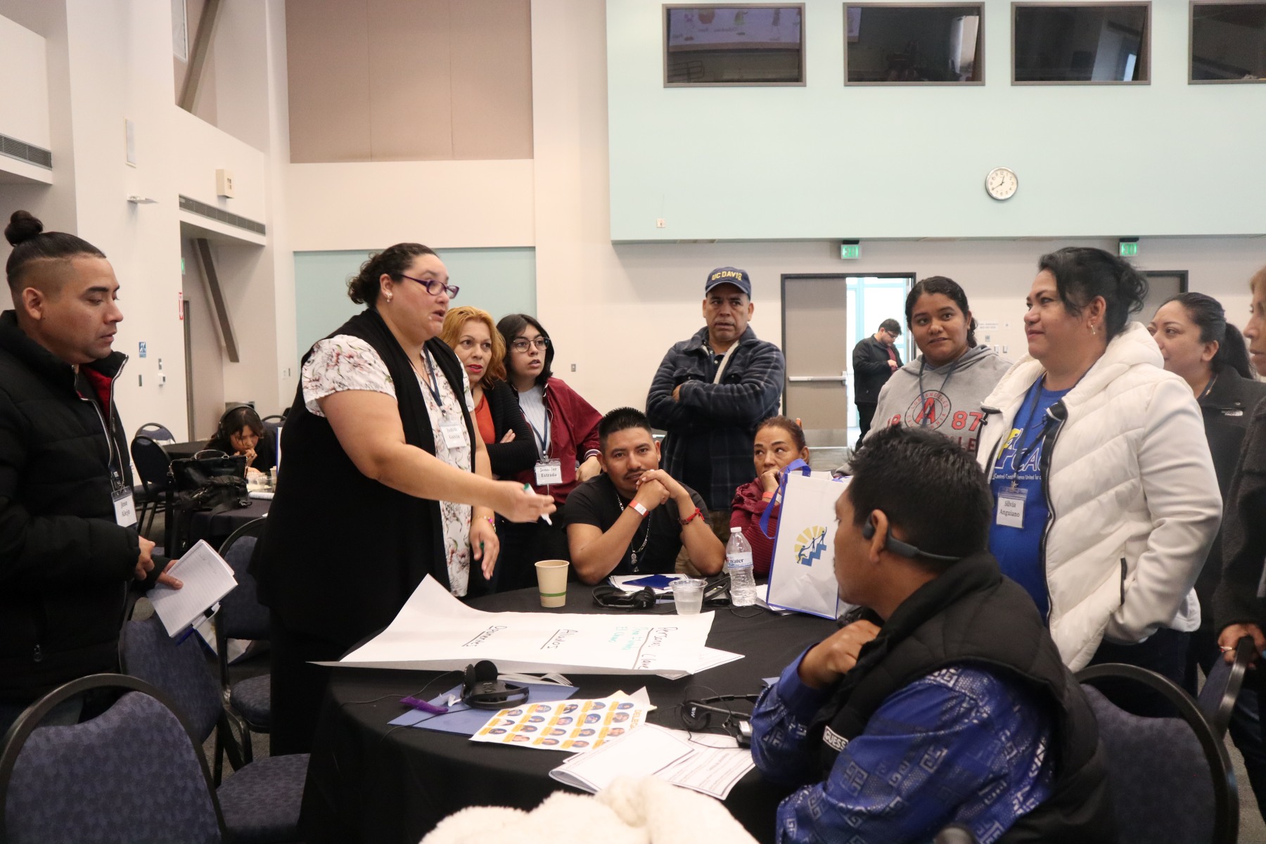 Community members at a roundtable engage in debate and discussion