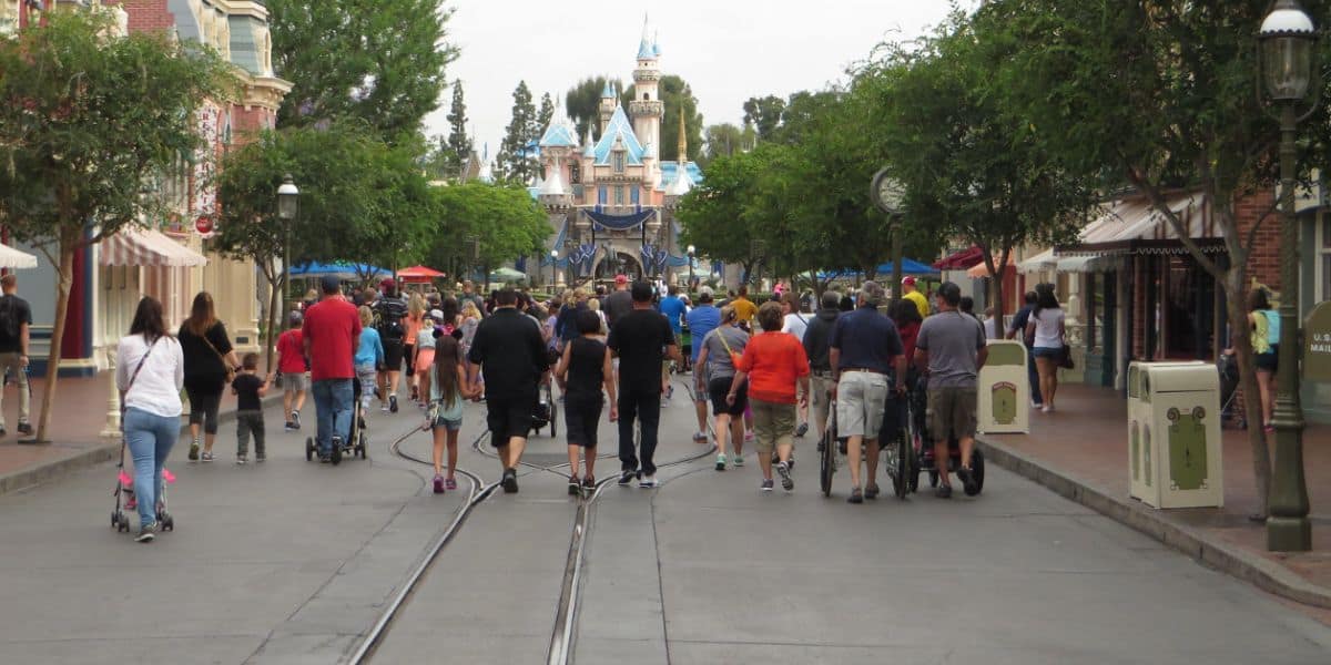 People walking on a quiet Main Street, U.S.A., at Disneyland Park, similar to the crowd levels people say are hitting the Southern California Disney parks.