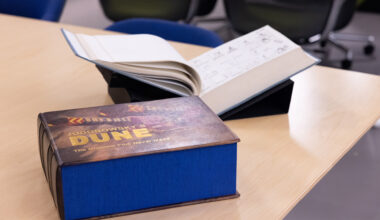 A large rectangular book sl;ipcase entitled Jodorowsky's Dune The Greatest Film Never Made with the book itself blurred in background.