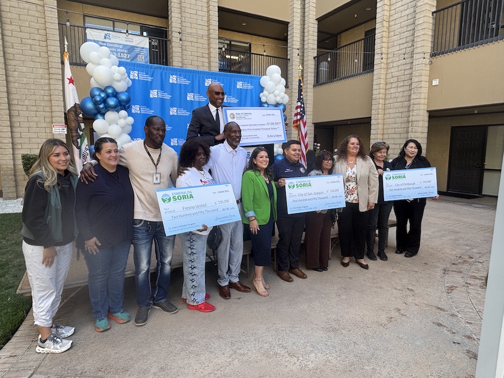 Assemblywoman Esmeralda Soria and community leaders pose with ceremonial checks announcing state funding for food assistance and senior meal programs in Fresno County.