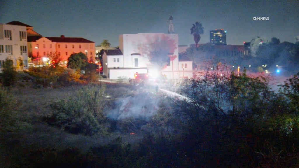 Firefighters at the scene where a brush fire near the Department of Veterans Affairs West Los Angeles Campus was stopped.