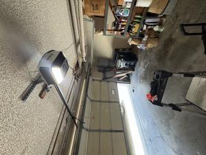 New modern smart garage door motor installed securely to the garage ceiling rail in Long Beach, California.