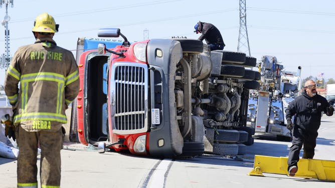 FILE - JURUPA VALLEY CA MARCH 14, 2024 Gusty Santa Ana winds toppled this Amazon box truck on the 60 Freeway east transition to the 15 Freeway north. It was a single vehicle accident with no injuries Thursday, March 14, 2024.