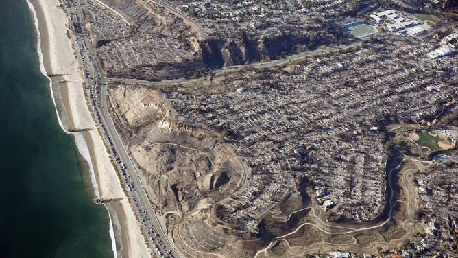 PACIFIC PALISADES, CALIFORNIA - JANUARY 13: An aerial view of homes destroyed in the Palisades Fire as wildfires cause damage and loss through the LA region on January 13, 2025 in Pacific Palisades, California. Multiple wildfires fueled by intense Santa Ana Winds continue to burn across Los Angeles County, with some containment achieved. According to reports, 24 people have died with over 180,000 people under evacuation order or warning. Over 12,000 structures have been destroyed or damaged, while more than 35,000 acres have burned. (Photo by Mario Tama/Getty Images)