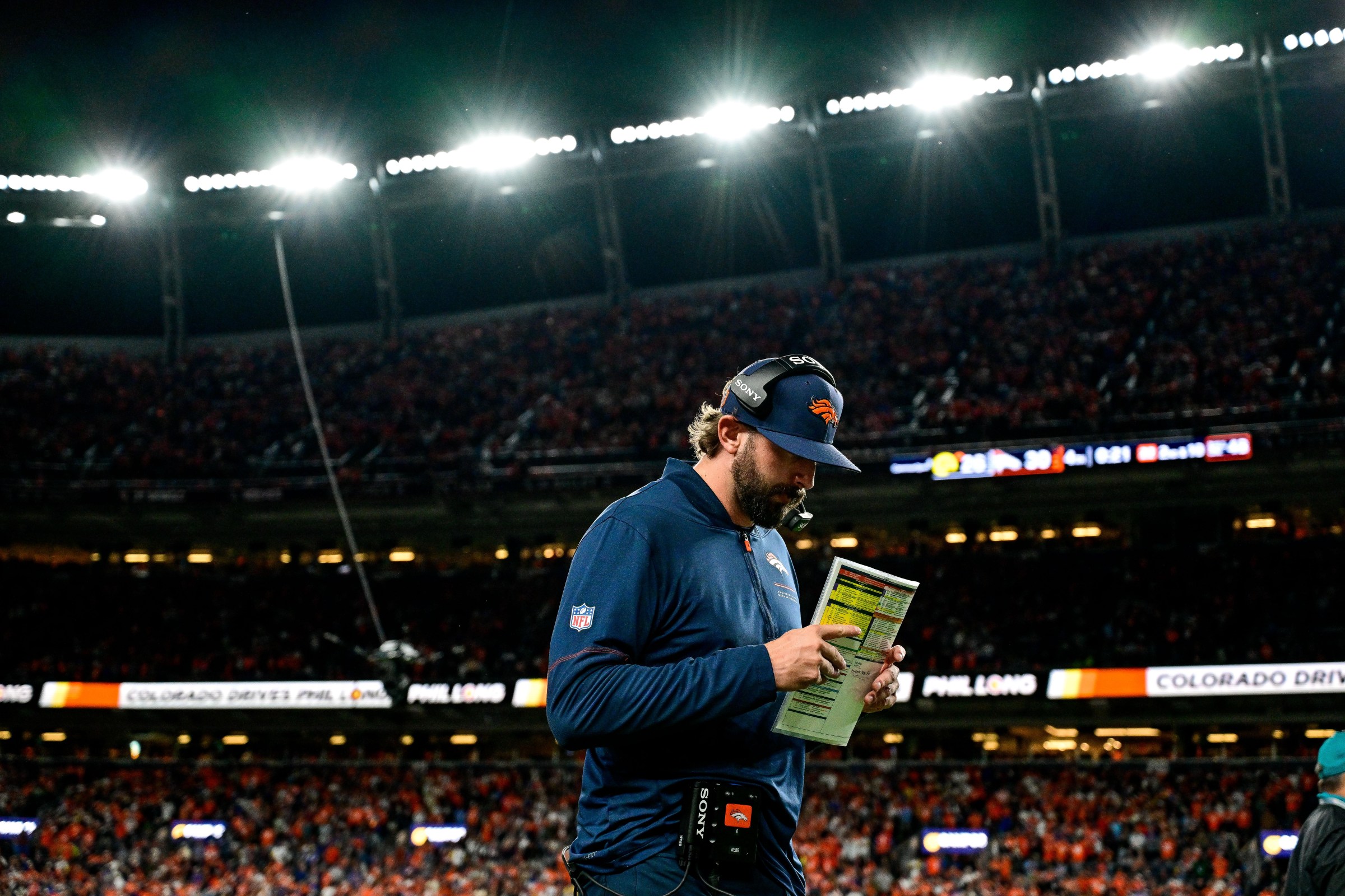 DENVER, CO - SEPTEMBER 27: Denver Broncos offensive coordinator Davis Webb walks along the sideline during a game between the Los Angeles Rams and the Denver Broncos at Empower Field at Mile High on September 27, 2026 in Denver, Colorado. (Photo by Dustin Bradford/Icon Sportswire via Getty Images)