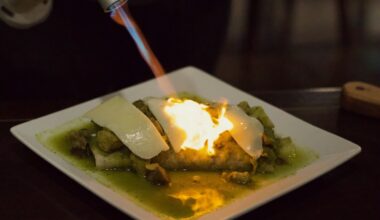 burrito with cheese being melted by a torch