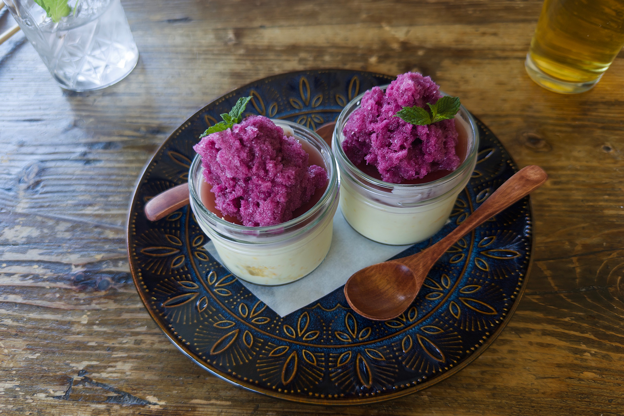Two small jars of bright purple shaved ice.