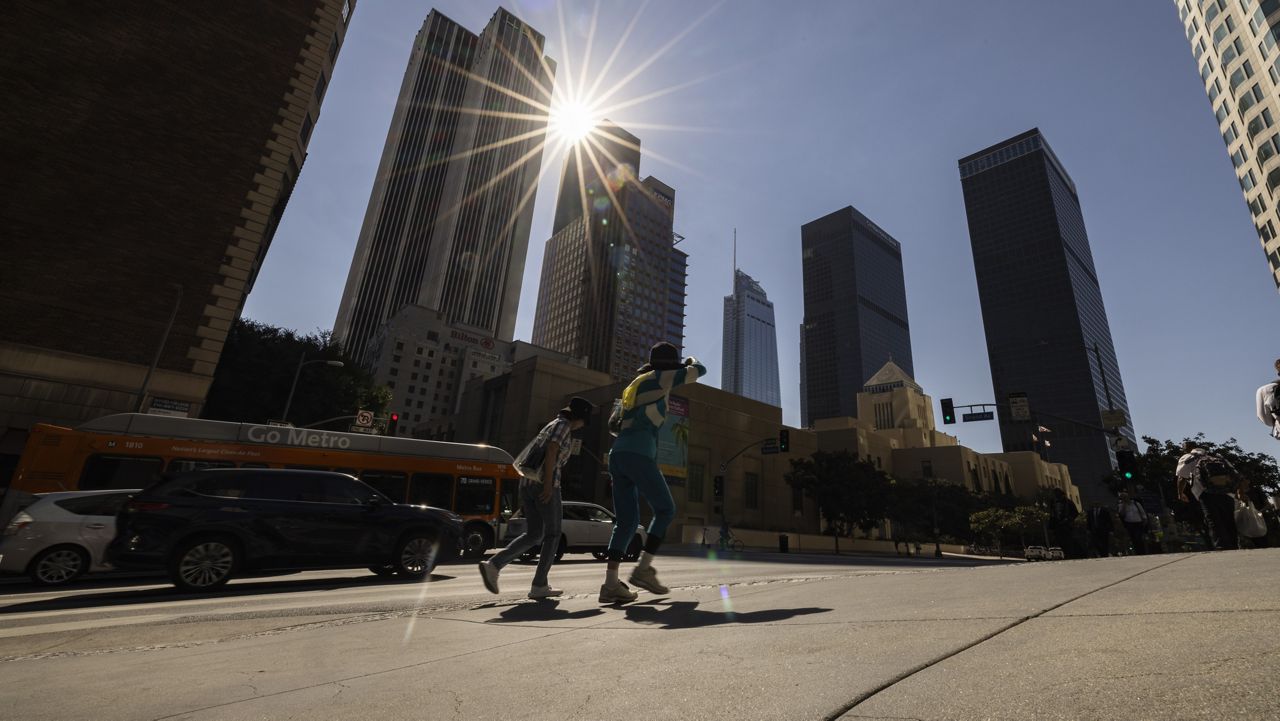 The sun shines over the financial district towers of downtown Los Angeles as Southern California is hit by a heatwave Friday, Sept. 6, 2024, in Los Angeles. (AP Photo/Etienne Laurent)