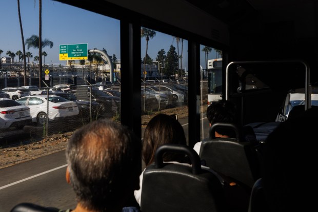 San Diego, California - Travelers take a free shuttle to the airport from Old Town Transit Center on Thursday, Oct. 1, 2026. (Kristian Carreon / The San Diego Union-Tribune)