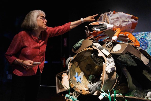 San Diego, California - Judy Gradwohl, president and CEO of The San Diego Natural History Museum, points specific parts of a piece at the museum's newest exhibit, Washed Ashore, in Balboa Park on Thursday, Aug. 13, 2026. (Kristian Carreon / The San Diego Union-Tribune)