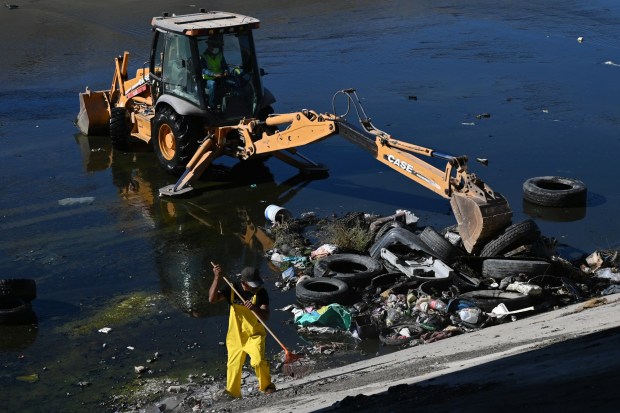 Wildcoast and Baja California environmental groups with university organizations and state authorities organized to help remove trash and old tires from the Tijuana River channel in Tijuana, Mexico on Friday, October 2, 2026. State government officials have been planning and preparing for possible El Niño weather pattern changes that are expected to occur during the fall and winter seasons with possible heavy rain and other related water issues. (Carlos Moreno / The San Diego Union-Tribune)