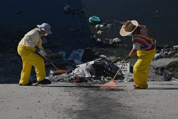 Wildcoast and Baja California environmental groups with university organizations and state authorities organized to help remove trash and old tires from the Tijuana River channel in Tijuana, Mexico on Friday, October 2, 2026. State government officials have been planning and preparing for possible El Niño weather pattern changes that are expected to occur during the fall and winter seasons with possible heavy rain and other related water issues. (Carlos Moreno / The San Diego Union-Tribune)