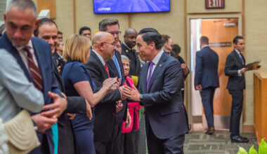 San Diego Mayor Todd Gloria shakes hands with Councilmember Henry L. Foster III after delivering his State of the City speech on Wednesday, Jan. 15, 2025. / Photo by Vito di Stefano for Voice of San Diego