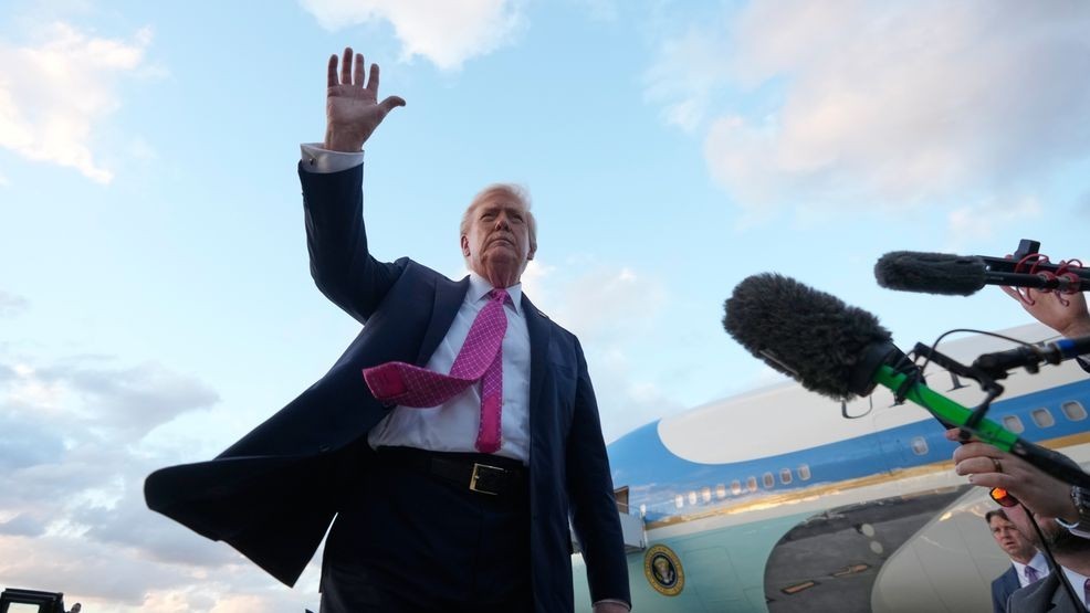 President Donald Trump waves after arriving on Air Force One, Friday, Oct. 17, 2025, at Palm Beach International Airport in West Palm Beach, Fla. (AP Photo/Mark Schiefelbein)