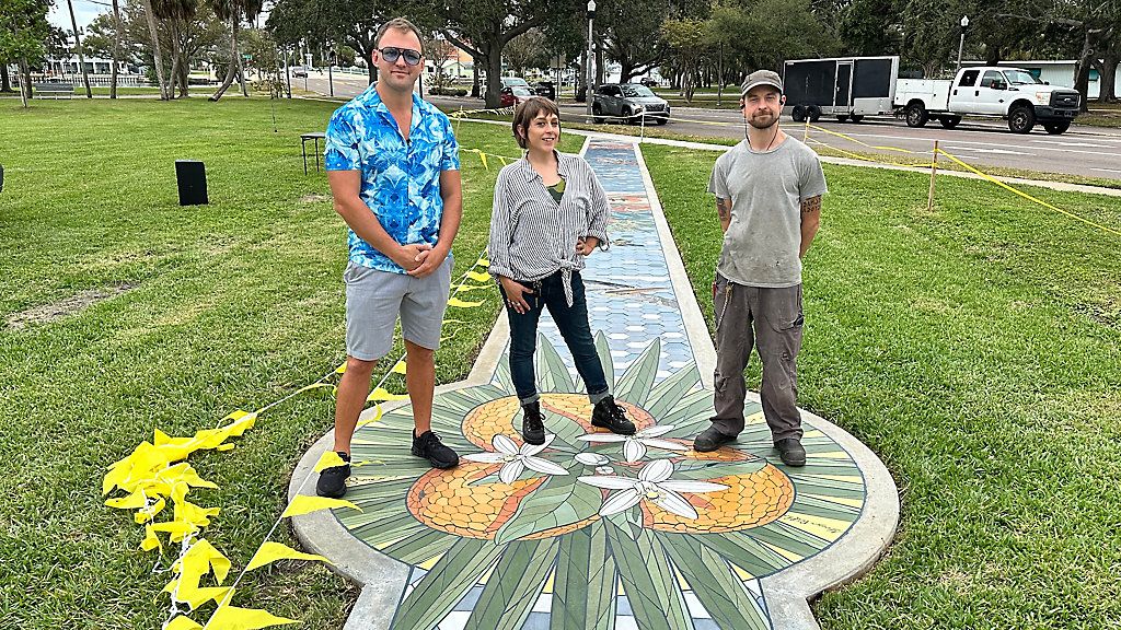 (From left to right) Artists Alex Kaufman, Laura "Miss Crit" Spencer and George Retkes unveiled their 175 foot long walkable Sunshine City Mosaic aimed at drawing visitors to Sunset Park in St. Petersburg on Wednesday. (Spectrum News/Josh Rojas)