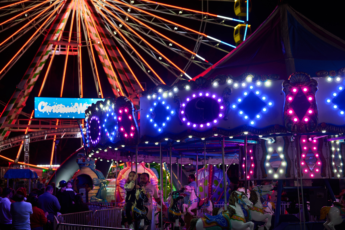 Carousel and ferris wheel in the background at Christmas Wonderland