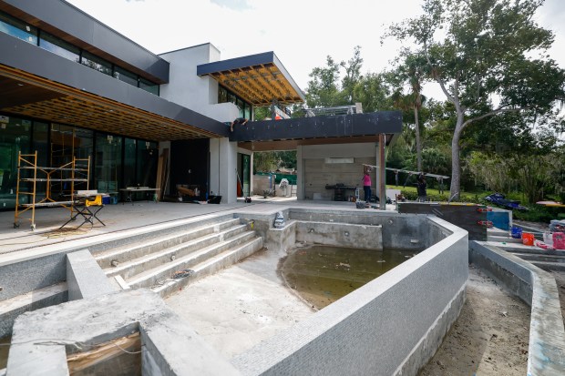 The outdoor entertaining space will feature an infinity pool, summer...