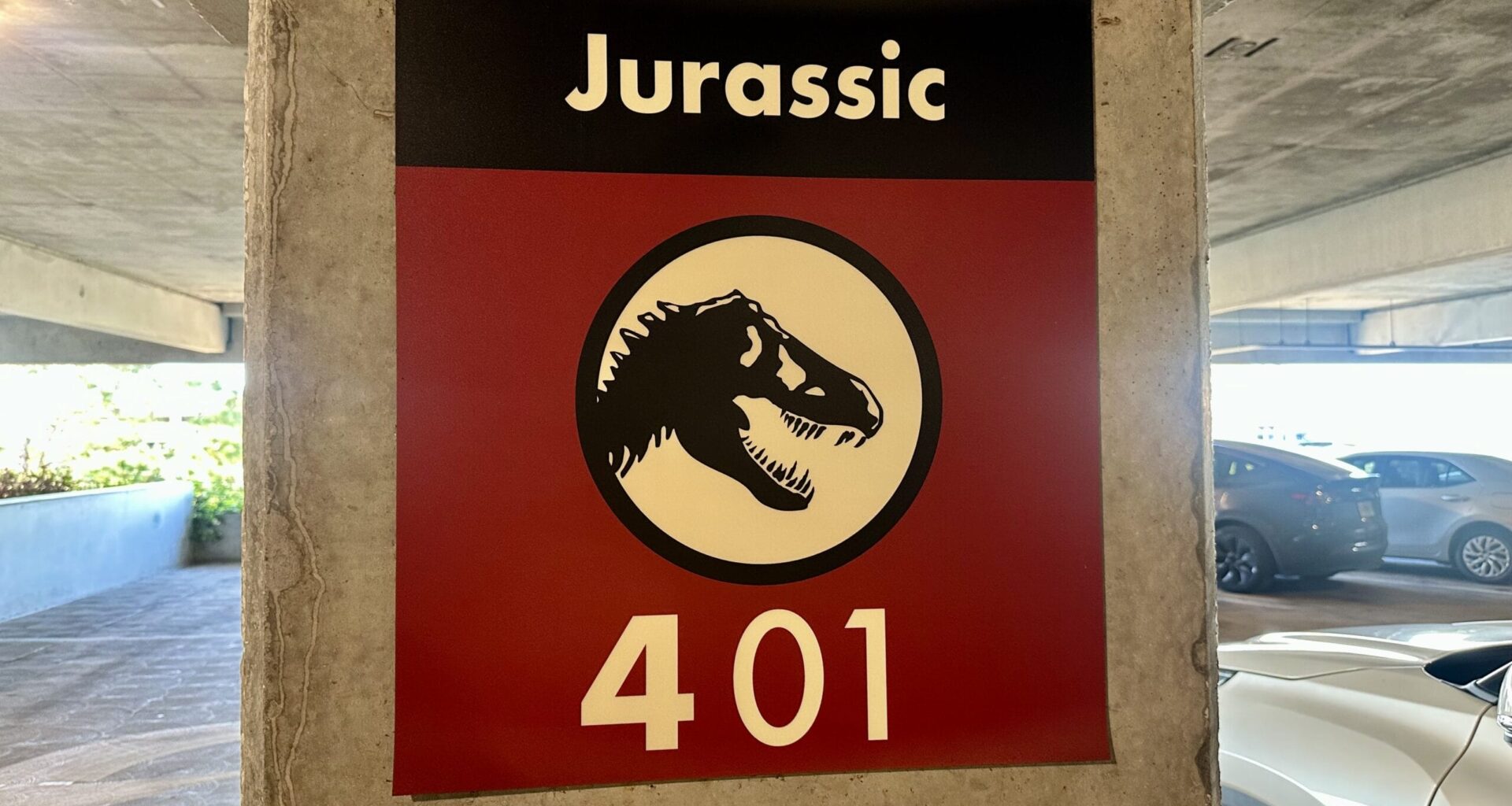 In the parking garage, a sign on a concrete pillar features a dinosaur silhouette with the text "Jurassic 401." It’s as intriguing as finding Butterbeer Treats at Universal Orlando Resort, adding an unexpected twist to your everyday tasks.