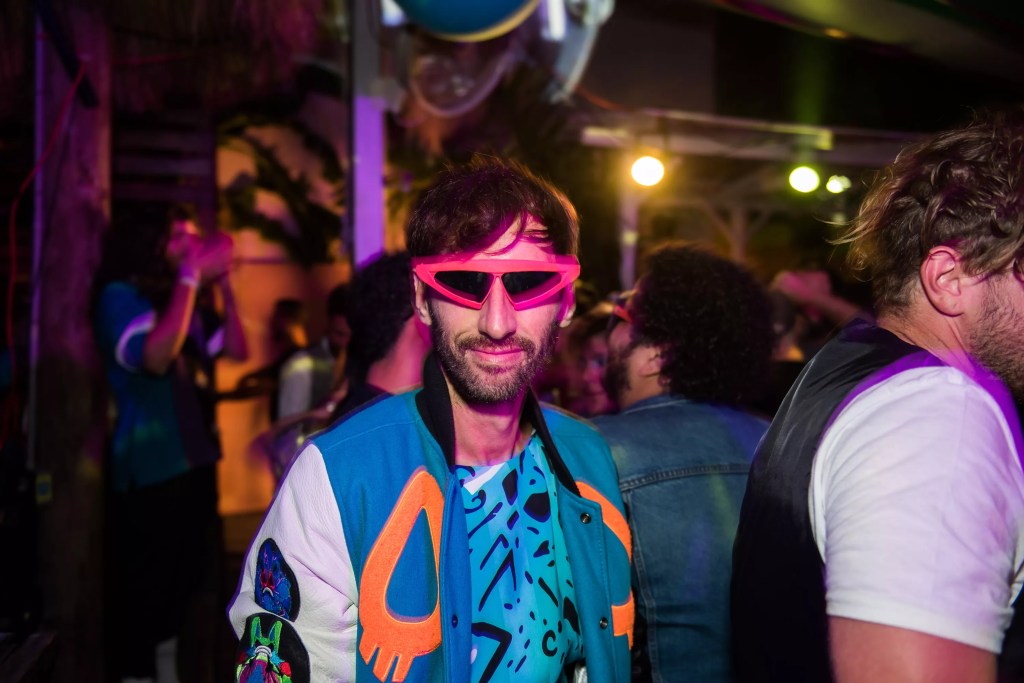 A man wearing '80s style sunglasses.