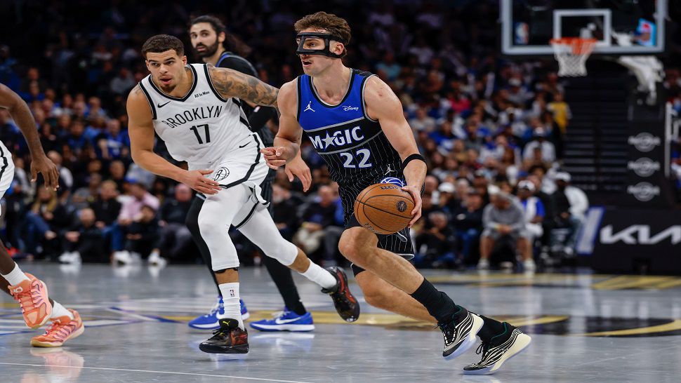 Orlando Magic forward Franz Wagner (22) drives against Brooklyn Nets forward Michael Porter Jr. (17) during the second half of an NBA Cup basketball game, Friday, Nov. 14, 2025, in Orlando, Fla. (AP Photo/Kevin Kolczynski)