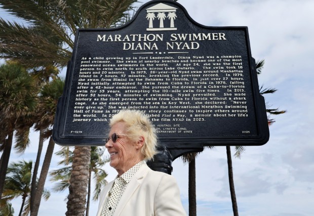 MarathonSwimmer Diana Nyad stands in front of a State Historical Marker along East Las Olas Blvd. in Fort Lauderdale on Thursday. (Carline Jean/South Florida Sun Sentinel)