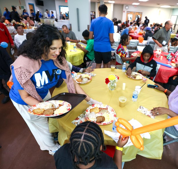 Volunteers serve at the Orlando Magic 33rd Annual Thanksgiving Breakfast...