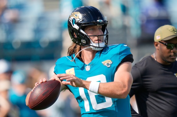 Jacksonville Jaguars quarterback Trevor Lawrence throws before an NFL football...