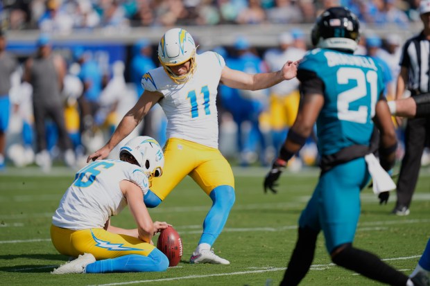 Chargers kicker Cameron Dicker (11) kicks a field goal out...