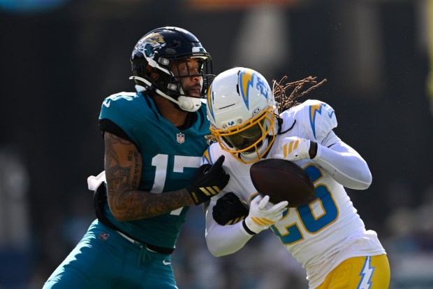 Chargers cornerback Donte Jackson (26) intercepts a pass against Jacksonville...