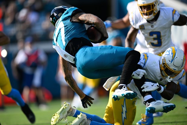 Jacksonville Jaguars wide receiver Tim Patrick (17) is tackled by...