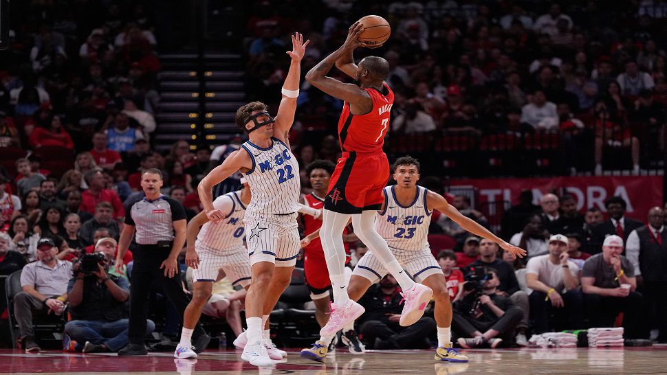 Houston Rockets forward Kevin Durant (7) shoots against Orlando Magic forward Franz Wagner (22) and forward Tristan da Silva (23) during the first half of an NBA basketball game in Houston, Sunday, Nov. 16, 2025. (AP Photo/Ashley Landis)